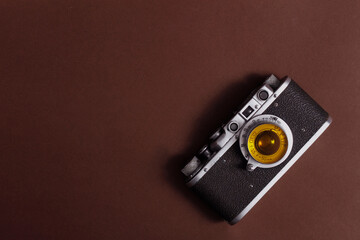 vintage photo camera, brown background, view from above, horizontal