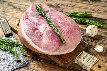 Slice of raw pork knuckle, leg. Farm fresh meat. Wooden background. Top view - obrazy, fototapety, plakaty