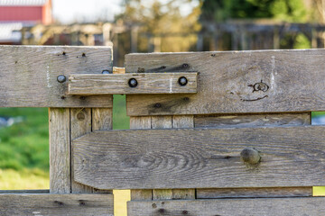 part of old farm gate closeup with blurry background.