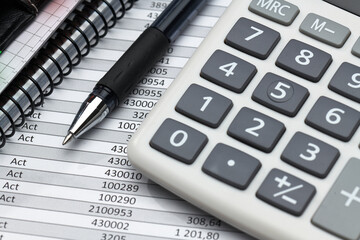 business office desk closeup - financial reports, analysis and accounting, set of documents, tables and graphs, various items for bookkeeping, calculator