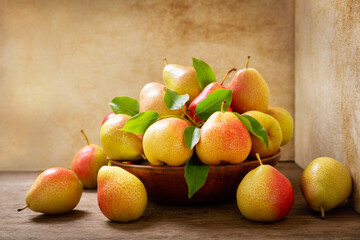 fresh pears in a bowl on a wooden table