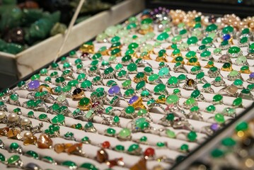This image shows a vendors display of dazzling jade rings and jewelry.of a motherboard