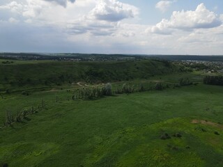 Aerial view of green hill on a cloudy day