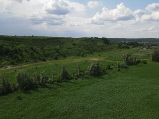 Aerial view of green hill on a cloudy day