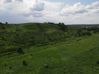 Aerial view of green hill on a cloudy day