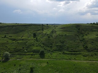 Aerial view of green hill on a cloudy day