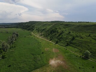 Aerial view of green hill on a cloudy day