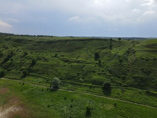 Aerial view of green hill on a cloudy day