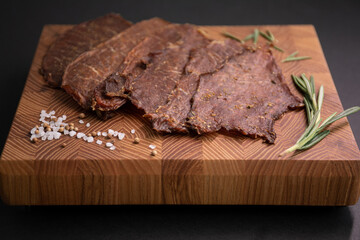 Close-up of a piece of meat on a wooden Board with spices. Restaurant menu, a series of photos of different dishes