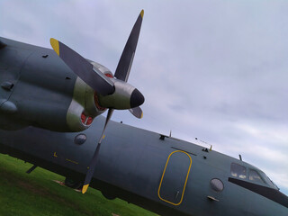 Fuselage of gray airplane and wing with propeller