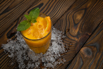 Cocktail. Orange juice with mint and ice rustic wooden table