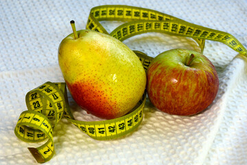 Apple, pear and centimeter tape. Diet for weight loss. Healthy fruits.