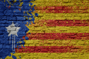 painted big national flag of catalonia on a massive old brick wall