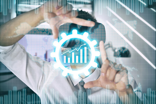 Trader with virtual reality glasses using chart in abstract cog hologram.