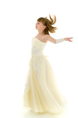 A beautiful little girl stands in the wind, her hair and clothes