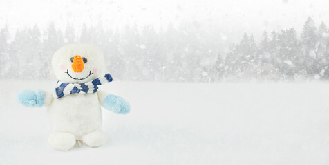 Little snowman on a winter background with copy space. Christmas background. New Year card. Banner.