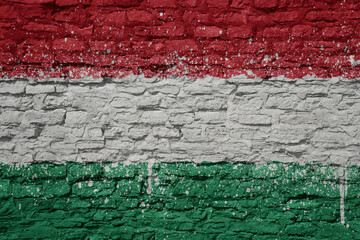 painted big national flag of hungary on a massive old brick wall
