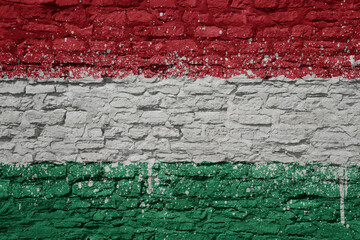 Fototapeta premium painted big national flag of hungary on a massive old brick wall