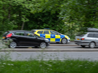 Police car driving through traffic