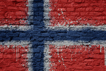 painted big national flag of norway on a massive old brick wall