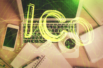 Blockchain theme hologram drawings over computer on the desktop background. Top view. Double exposure.