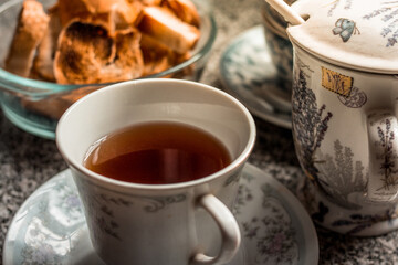 Close up cup of tea with teapot and toast for breakfast