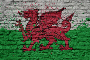 painted big national flag of wales on a massive old brick wall