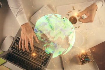 Double exposure of man's hands typing over computer keyboard and social network theme hologram drawing. Top view. People connection web concept.