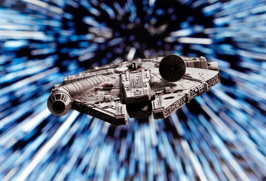 NEW YORK USA - MAY 23 2020: scene from Star Wars - Corellian freighter Millennium Falcon travels through Hyperspace - Kessel Run - X-Wing miniature game ship
