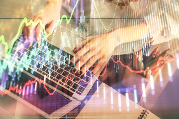Double exposure of woman hands typing on computer and forex chart hologram drawing. Stock market invest concept.