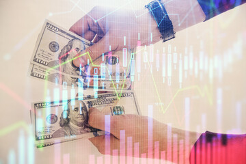 Multi exposure of financial graph drawing hologram and USA dollars bills and man hands. Analysis concept.