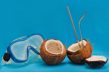Diving mask and coconut halves with reusable. Minimalistic summer concept