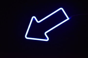 A blue LED arrow with a black background