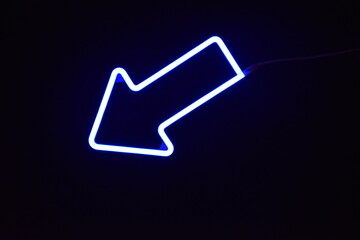 A blue LED arrow with a black background
