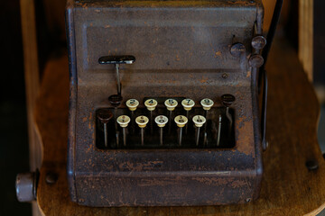 Details of a retro rustic old fashioned mechanical adding calculator from the 19th century