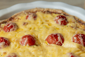 Homemade quiche lorraine with chicken, tomatoes and cheese. French cuisine. Selective focus. Top view. Copy space
