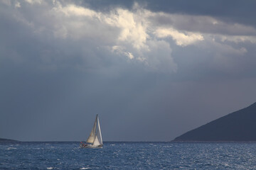 Sailing ship yachts with white sails in race the regatta in the open sea	