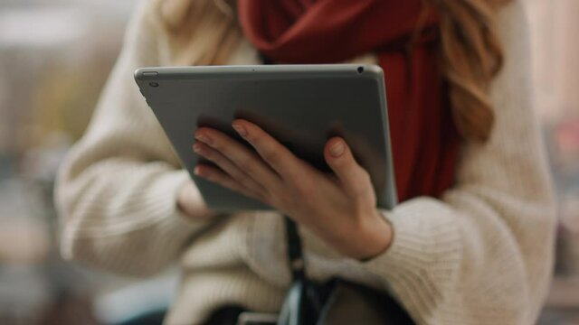 Unknown girl typing tablet computer outdoors. Woman hands holding digital tablet