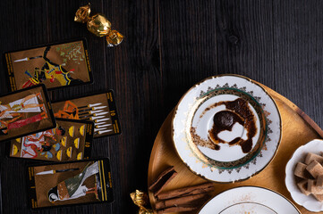 Illustrative- editorial : JUNE 11, 2020 - Saint Peterburg, Russia: spelling coffee plate  with  coffee grounds and Nefertari Tarot cards served at dark wooden table. devination concept