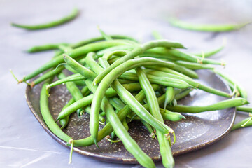 Bunch of fresh green beans on a plate. String Beans. Close-up