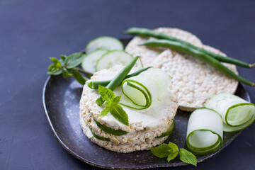 Healthy food. Rice sandwich with cucumber and green beans. Rice cakes with cream cheese, herbs. Morning sandwich. Copyspace