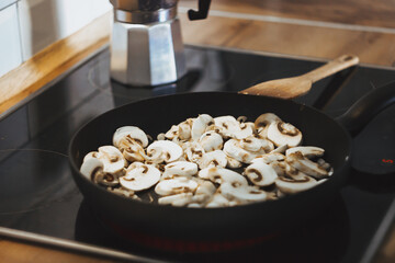 pan with mushrooms, fried mushrooms at home. Fried mushrooms with olive oil