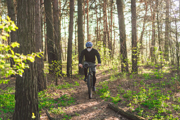 Young man in protective mask from environmental pollution riding mountain bike on cross country road. Cyclist Riding the Bike on Trail in Forest. Face pollution mask smog dust pm2.5 protection