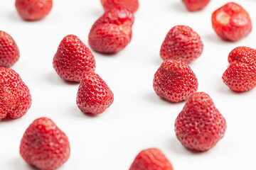lots of strawberries on a white background, use as a background or texture