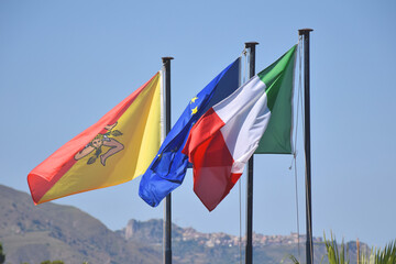 signos de un territorio, las banderas de la union europea, italia y donde estan plantadas sicilia.