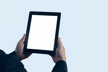 Mock up technology. Businessman in blue jacket is holding a tablet with a white screen on a light background.