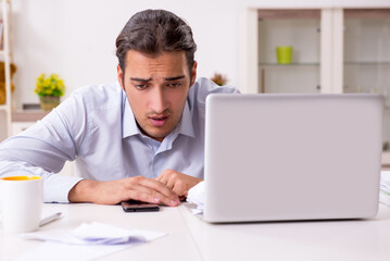 Young male businessman working at home