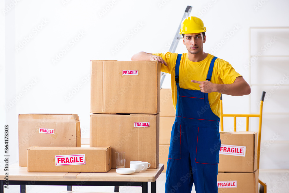 Wall mural young male professional mover doing home relocation