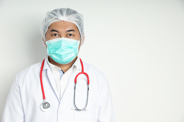 Asian man standing wearing a hairnet, wearing a medical mask, and having a red medical stethoscope. Isolated on a white background looking at the front camera with copy space on the right-hand side.