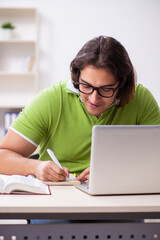 Young male student in the classroom